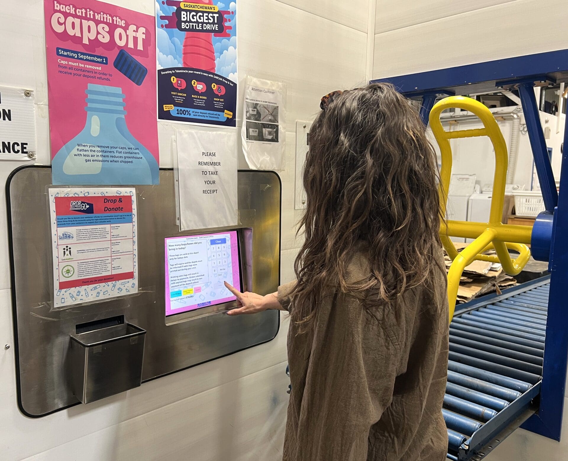 Woman uses the drop and go system at SARCAN to donate to SPCA.